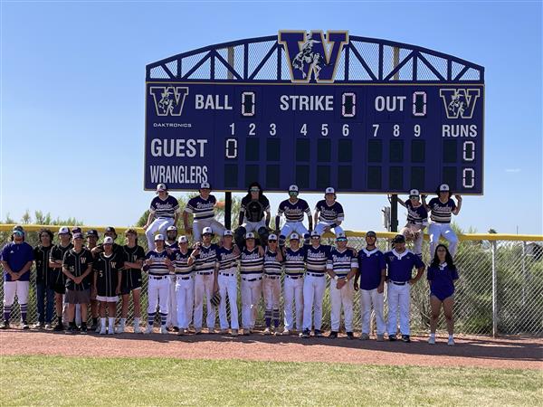 baseball team picture by scoreboard
